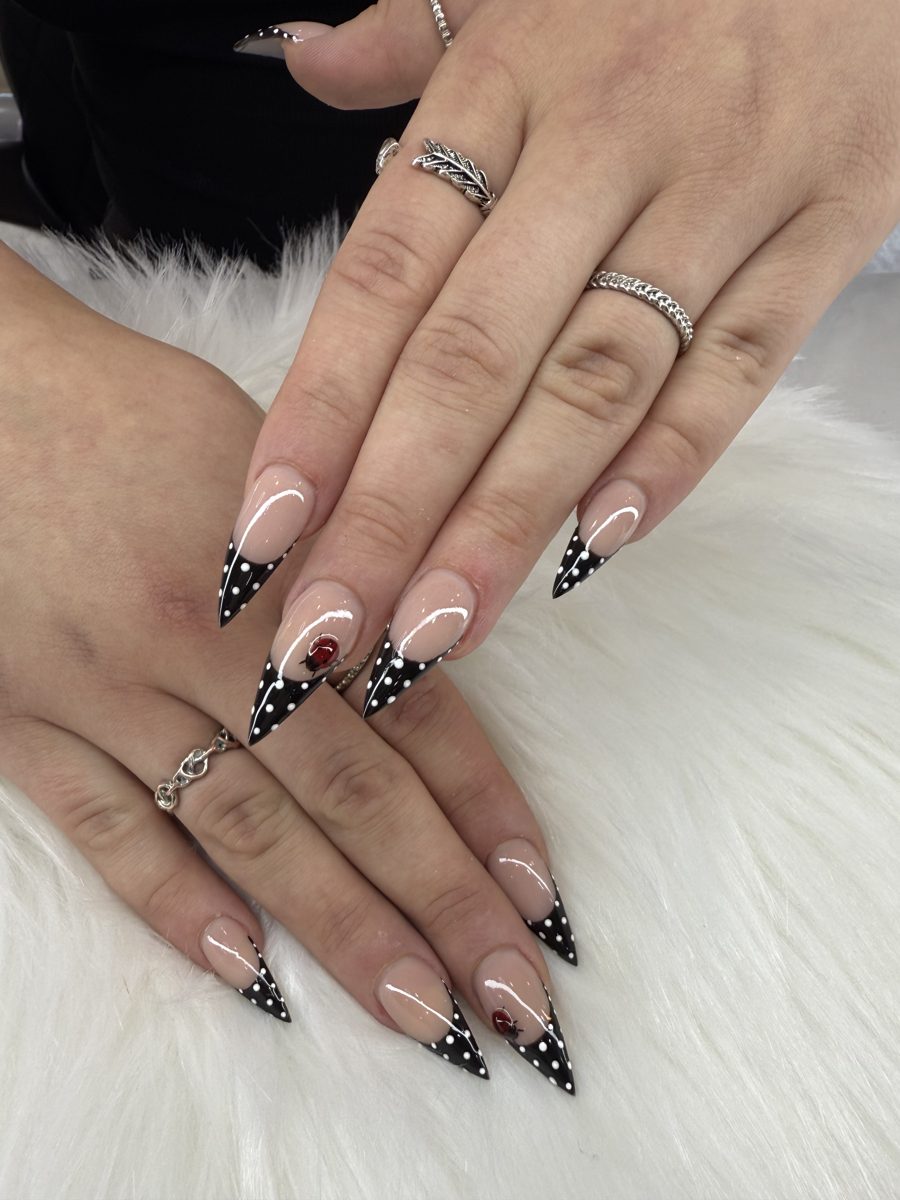 Stiletto nails with black polka-dot French tips and white bows
