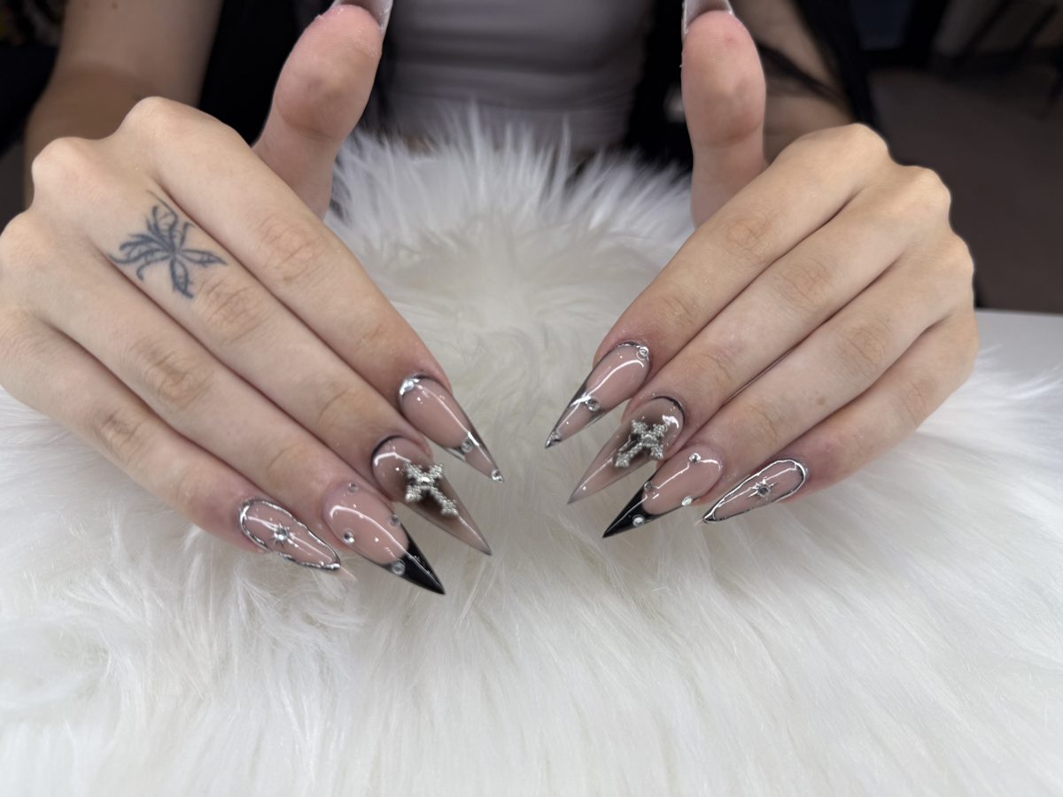 Sheer stiletto nails with silver chrome tips and cross charms