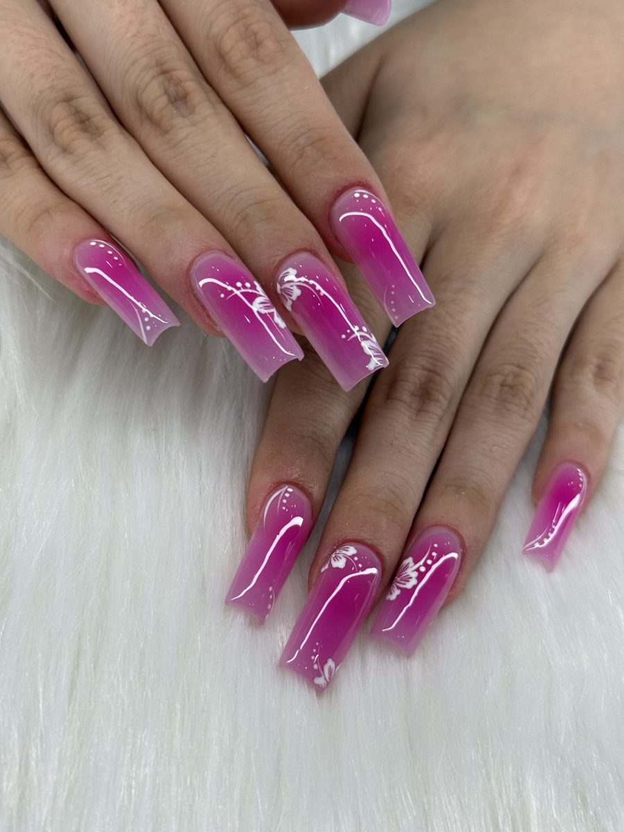 Long square nails in magenta cat-eye with white snowflake art