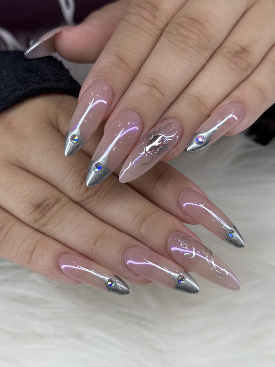 Long sheer pink almond nails with silver chrome tips and rhinestones